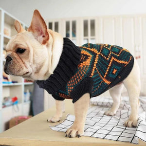 Dog wearing a Toggy Doggy stretchy dog sweater that has a pretty patterned design of bluish-black and orange alternately.